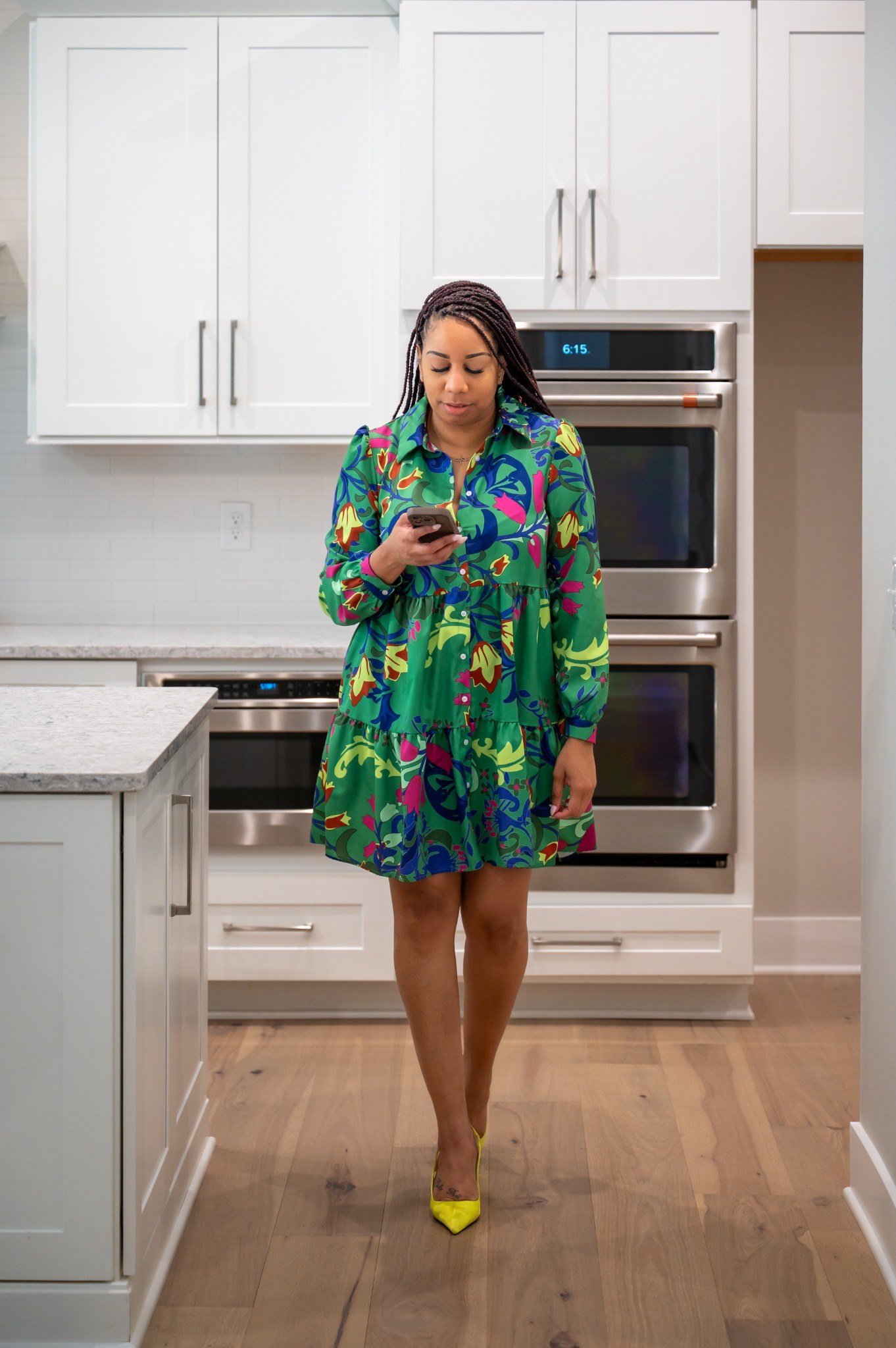 Kala standing in a bright model-home kitchen